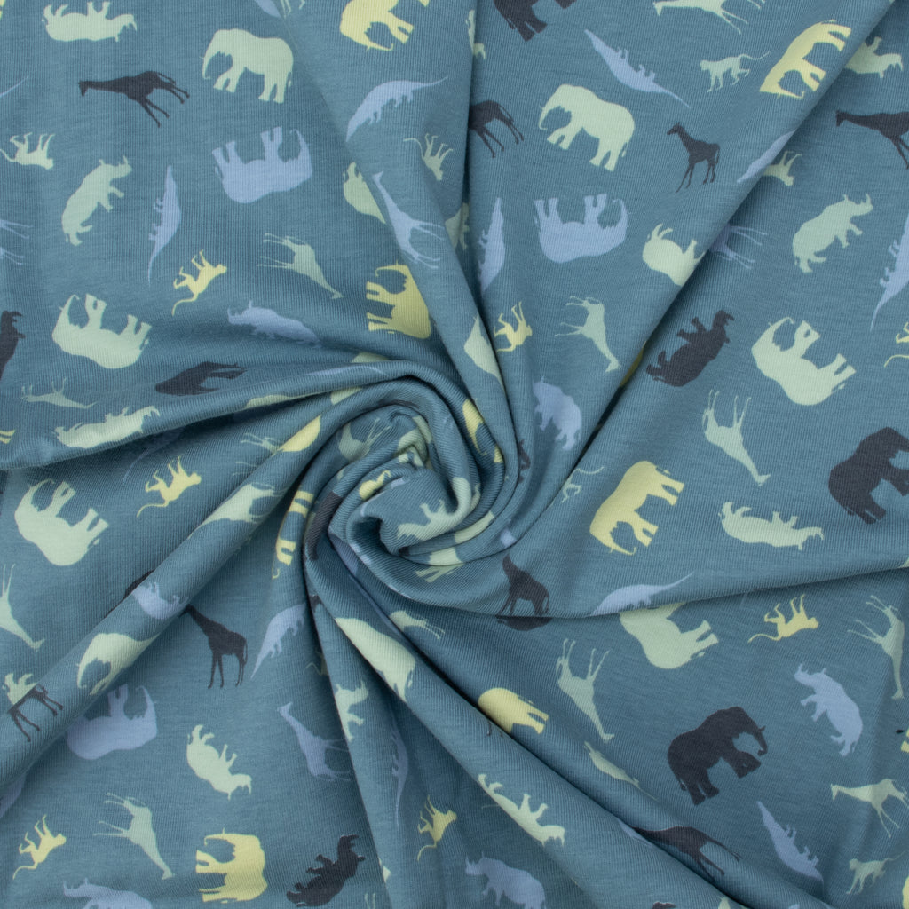 Jersey Safari Blau – Jerseystoff mit Tier-Silhouetten auf blauem Hintergrund